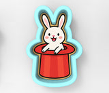 a sticker of a rabbit sitting in a red hat