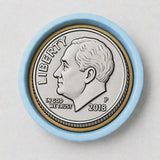 A silver-colored coin with a profile portrait of a man, surrounded by a blue border.
