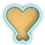 a heart shaped cookie cutter cut out of paper