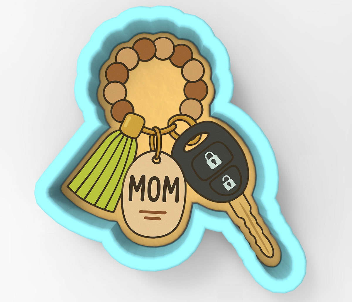 A cookie cutter shaped like a car key with a tassel and a keyring attached to it, along with a key-shaped tag that says "MOM".