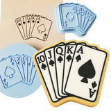 a cookie with playing cards and a cookie cutter