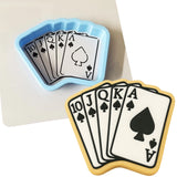 a cookie shaped like a playing card next to a cookie cutter