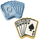 a cookie with a cookie cutter and four playing cards