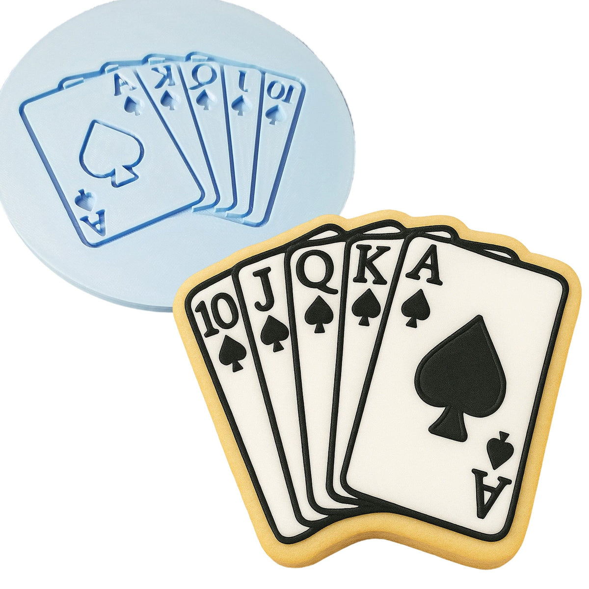 a cookie decorated with playing cards and a cookie cutter