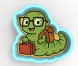 A green caterpillar wearing glasses and carrying a suitcase is depicted in the image.