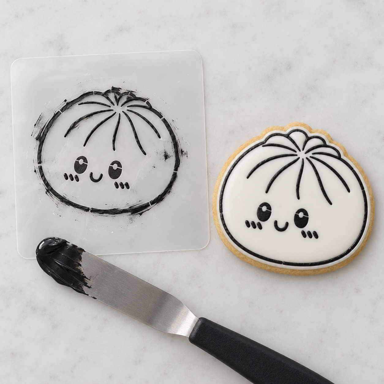 Dumpling stencil beside black icing applied to a white iced cookie