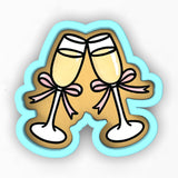 a pair of champagne glasses with pink bows