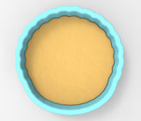 A blue-rimmed bowl filled with a yellow substance, likely a batter or dough, is shown in the image.