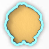 a cookie cutter with a cookie in the shape of a face