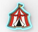 a red and white circus tent sitting on top of a white wall
