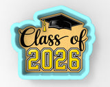 A graduation cap and the text "Class of 2026" in a cookie cutter shape.