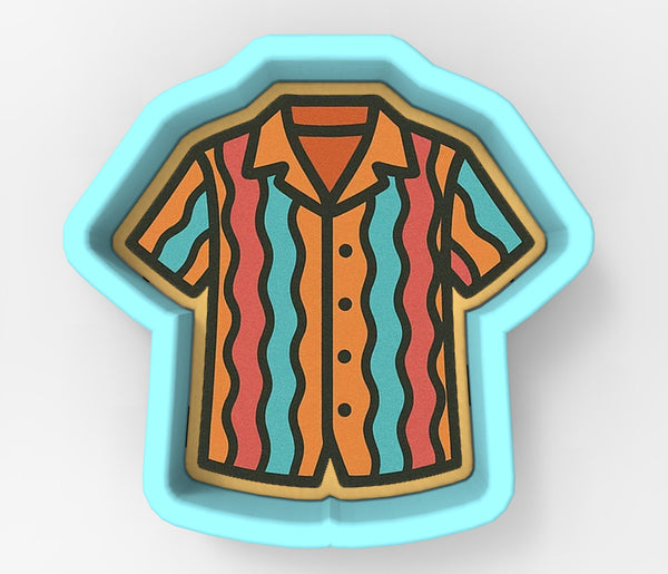 A cookie cutter in the shape of a colorful striped shirt.