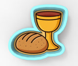 A loaf of bread and a wine glass are depicted in the image.