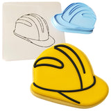 a cookie shaped like a hard hat next to a cookie cutter