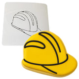 a cookie shaped like a helmet next to a drawing of a helmet