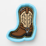 A blue cookie cutter shaped like a cowboy boot.