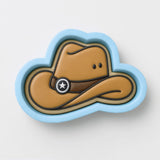 A cowboy hat cookie cutter in the shape of a cloud, with a star symbol on the front.