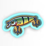 a fish shaped magnet with a hook on it