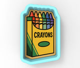 A crayon box cookie cutter with the word "CRAYONS" printed on it.