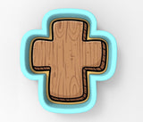 A wooden cross-shaped object with a blue border.