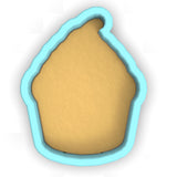 a cookie cutter with a cookie in the shape of a house