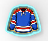 A blue and red hockey jersey with white stripes, designed as a cookie cutter.