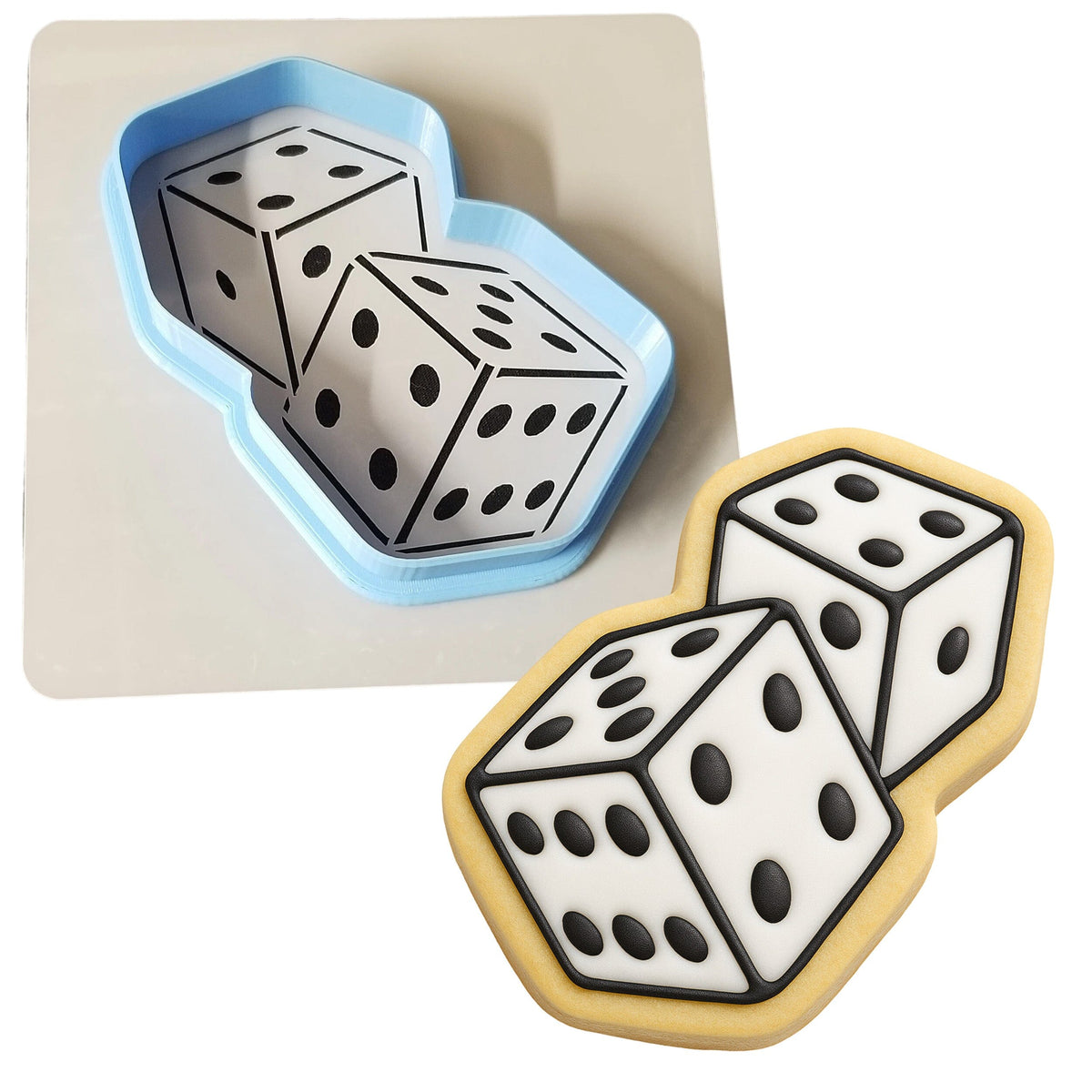 a cookie with a cookie cutter next to a cookie with two dices on it