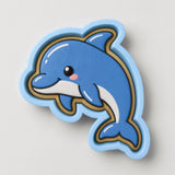 A blue cartoon dolphin with a pink nose and a smiling expression is depicted in the image.