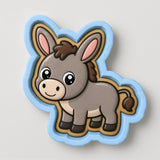 A cartoon donkey cookie cutter with a blue outline and a brown and white color scheme.