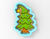A cookie cutter shaped like a Christmas tree with a star on top.