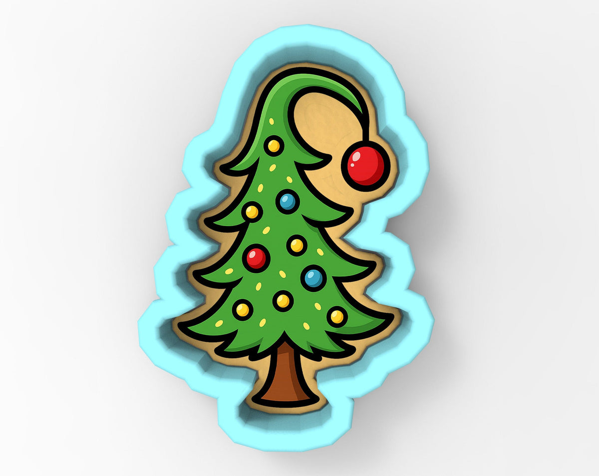 A cookie cutter shaped like a Christmas tree with colorful ornaments and a red ball on top.