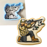 a cookie with a picture of a soldier shooting a gun