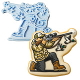 a cookie shaped like a man with a gun