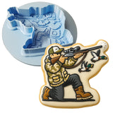 a cookie with a picture of a man shooting a bird