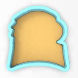 a cookie cutter with a piece of bread in the shape of a face