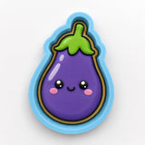A purple eggplant cookie cutter with a smiling face and a green stem.