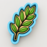 A blue cookie cutter shaped like a leaf with green leaves on it.