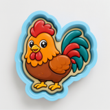 A cartoon image of a rooster in a blue and yellow cookie cutter.