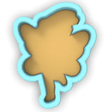 a cookie cutter shaped like a leaf