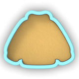 a cookie shaped cookie cutter sitting on top of a table