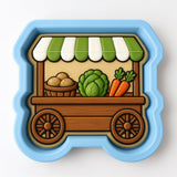 A blue and green toy wagon with a wooden frame, displaying various vegetables such as carrots, lettuce, and potatoes.