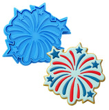 two cookie cutters decorated like fireworks on a white background