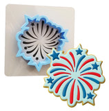 a cookie cutter next to a cookie shaped like an american flag