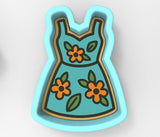 A blue dress with orange flowers on it, designed in a cookie cutter shape.