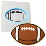 a cookie shaped like a football and a cookie cutter