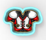 A cookie cutter in the shape of a football jersey, with red and white colors and black details.
