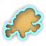 a cookie cutter with a cookie shaped like a fish