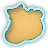 a cookie shaped like a bear on a white background