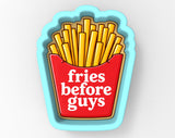 A cookie cutter shaped like a french fry container with the text "fries before guys" printed on it.