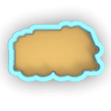 a cookie cutter with a cookie in the shape of a cloud